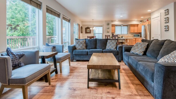 A spacious living area with a sofa set, a coffee table, and a dining table. - The perfect beach home for 10, 3 blocks to the beach, ocean views from the deck. (Lincoln City)