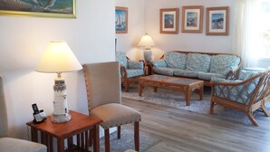 A living room with a sofa set, two chairs, a coffee table, and a lamp. There are framed pictures on the wall. - Spacious home, easy beach access, central location close to local attractions (Lincoln City)