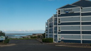 A multi-story hotel named 'Waters Edge' with a view of the beach and ocean.