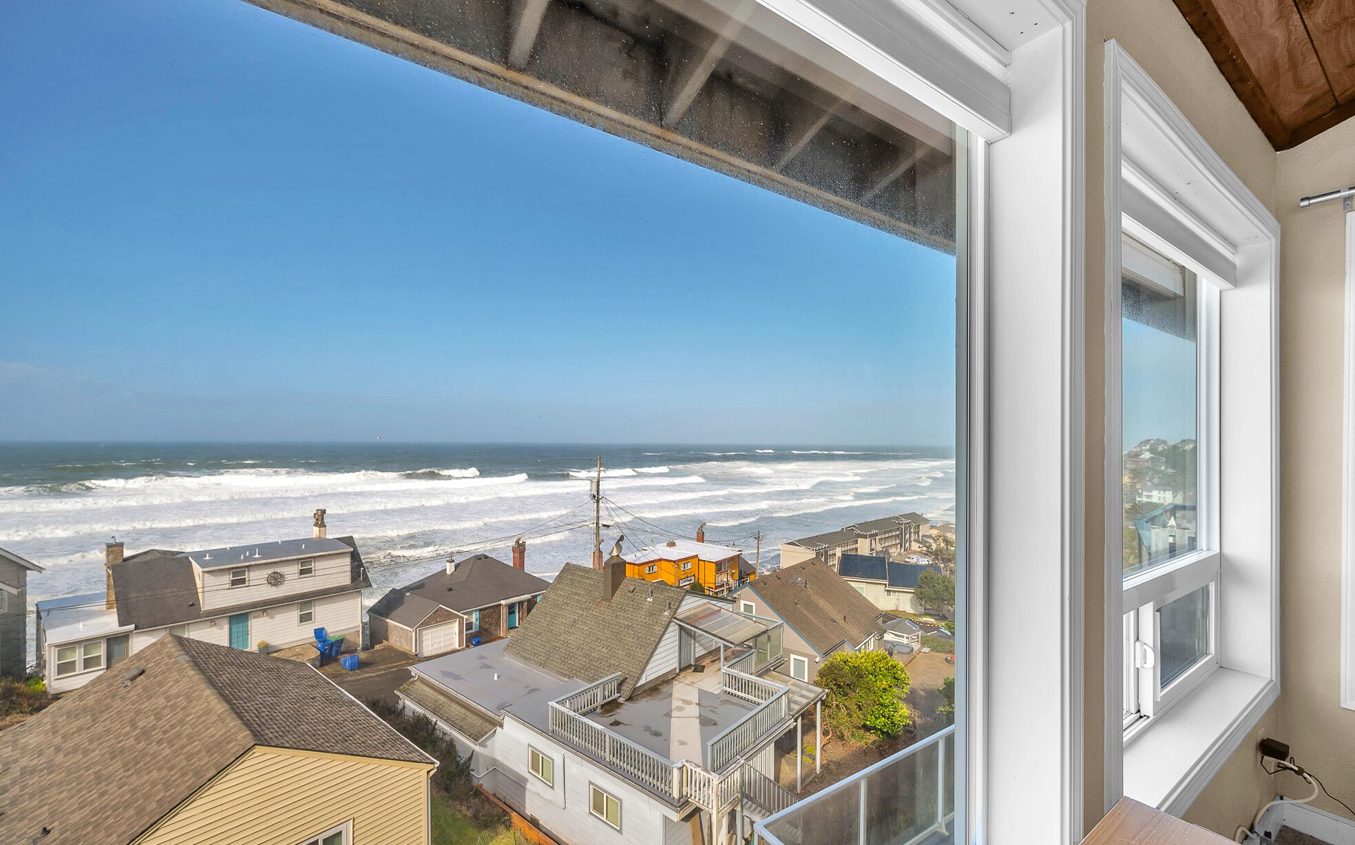 A coastal residential area with houses and a view of the ocean.