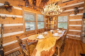 Enjoy meals in this cozy dining room with a large round table and rustic charm.