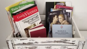A wooden crate filled with travel guides and books.