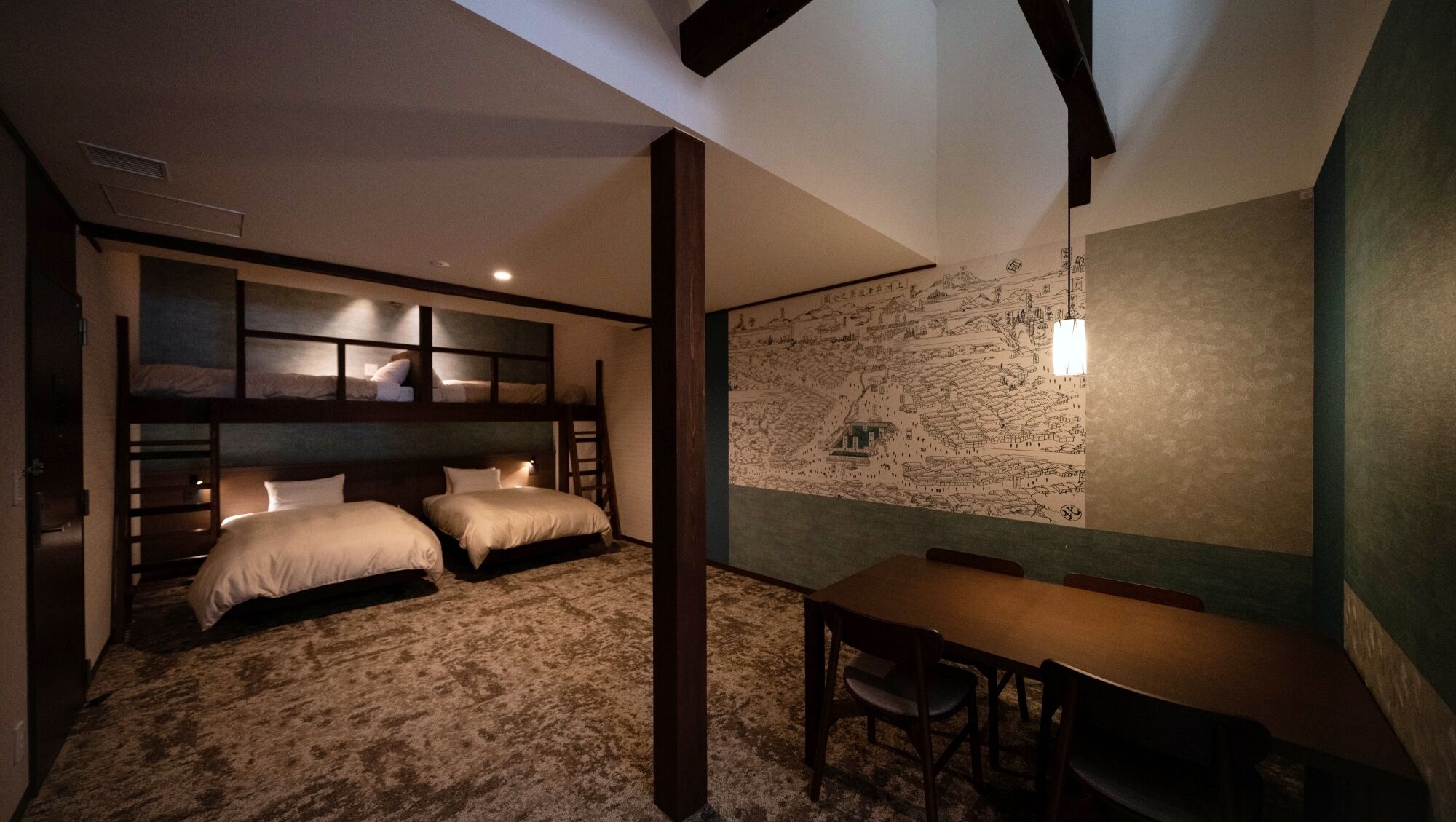 A room with bunk beds, a dining table, and a mural on the wall.