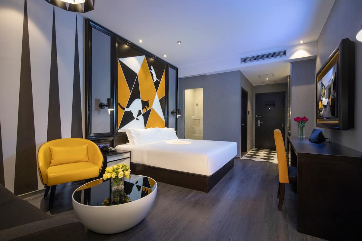 Minibar, escritorio, cortinas blackout y tabla de planchar con plancha