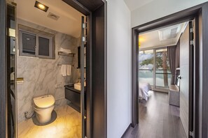 A modern bathroom with a toilet, sink, and towel rack. - Goseong Hansan Marina Resort (Goseong)