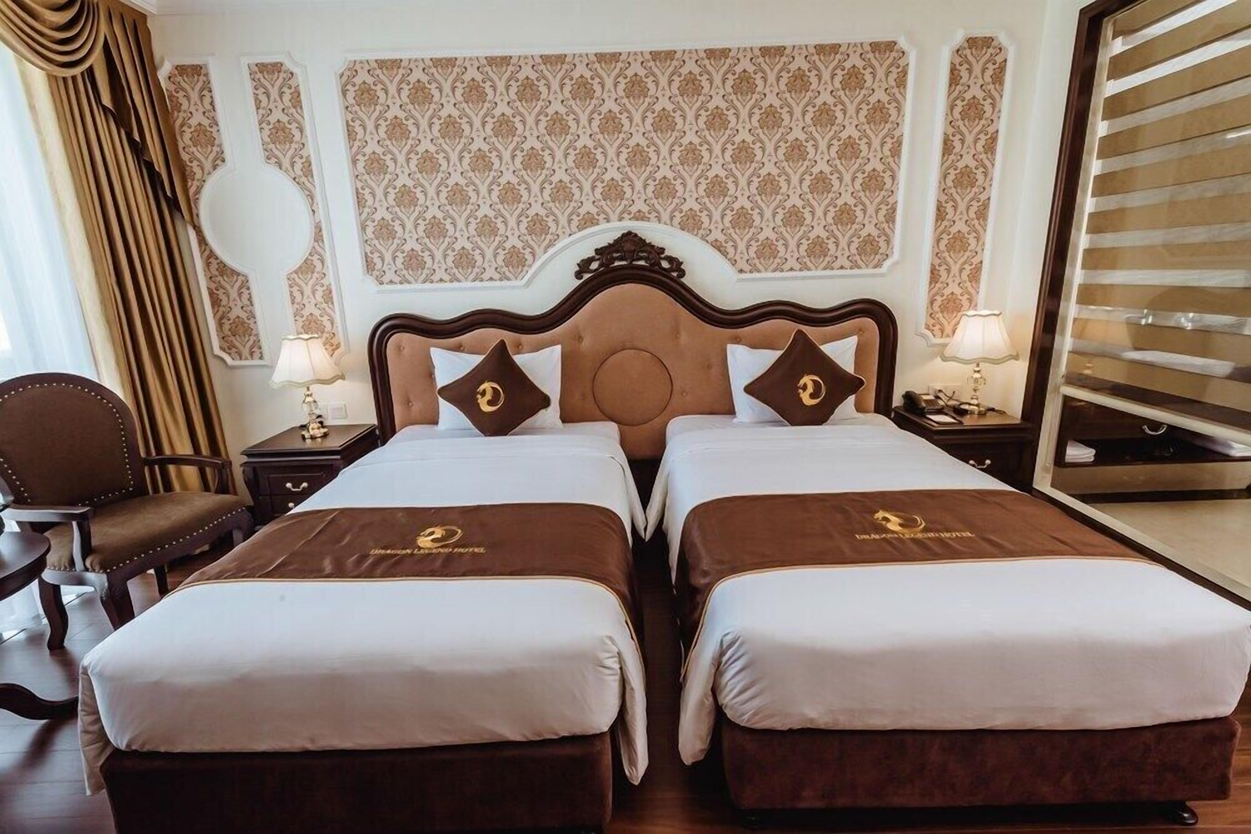 A hotel room with two beds, a large mirror, and a view of the city.