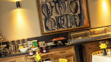 A restaurant interior with tables, chairs, a buffet, and a large abstract painting on the wall.