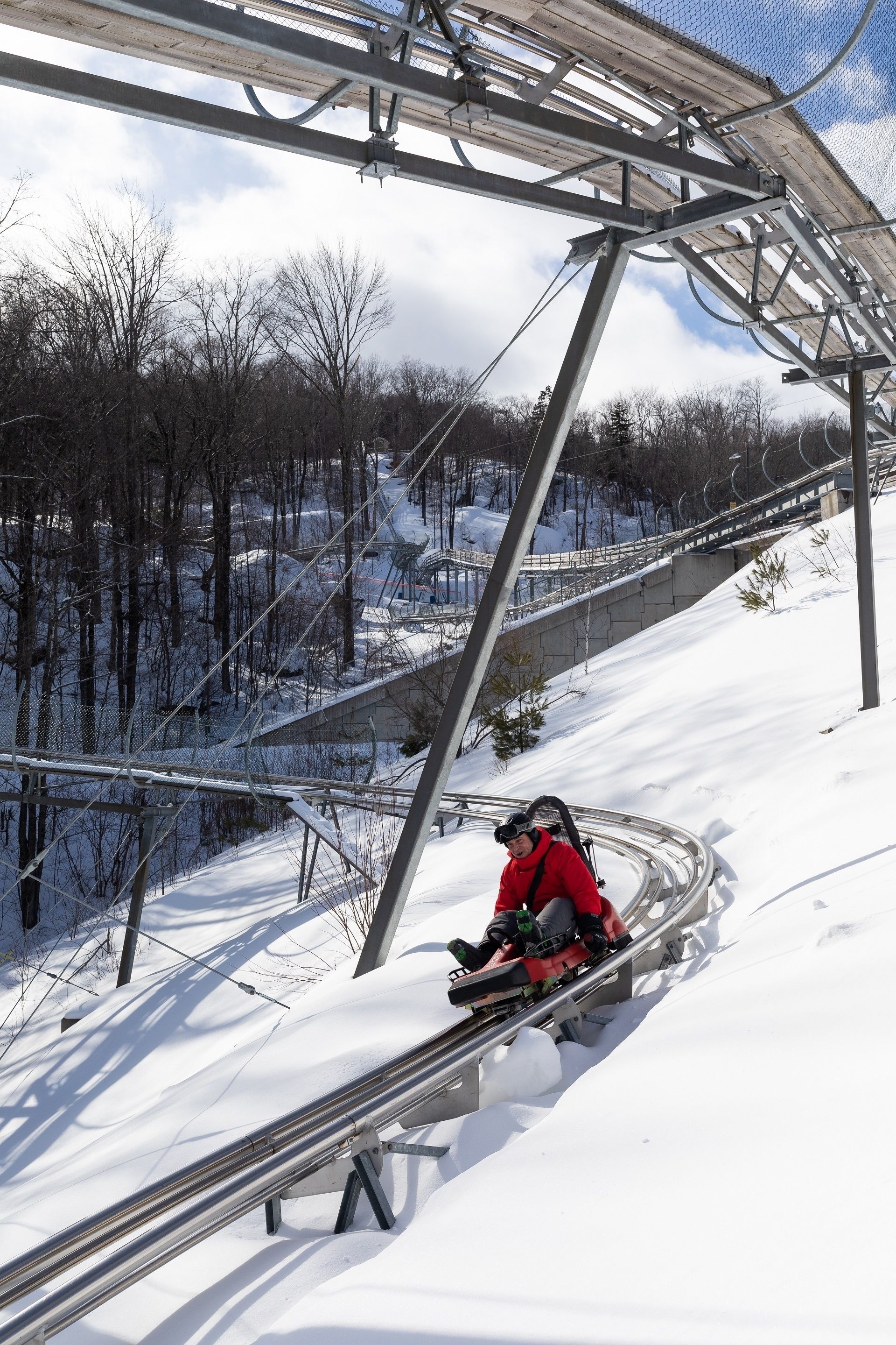 A ski lift with metal beams and a snowy landscape.