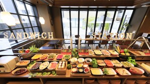 A buffet with various food options and a sign that reads "SANDWICH STATION". - Quintessa Hotel Fukuoka Hakata Relax&Sleep (Fukuoka)