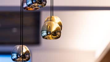 Three hanging spherical light fixtures with a reflective surface.