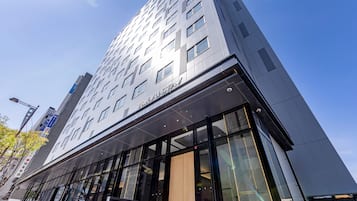 Un moderno edificio de hotel con una entrada destacada y amplias ventanas.