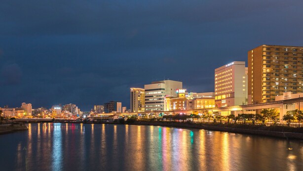 A cityscape with modern buildings along a waterfront. - Tokyu Stay Okinawa Naha (Naha)