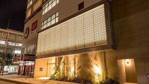 A hotel entrance with a large illuminated facade and a sign indicating 'Tokyo Stay'. - Tokyu Stay Okinawa Naha (Naha)