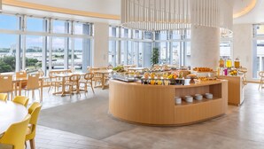 A modern dining area with a central counter, large windows, and a view of the cityscape. - Tokyu Stay Okinawa Naha (Naha)