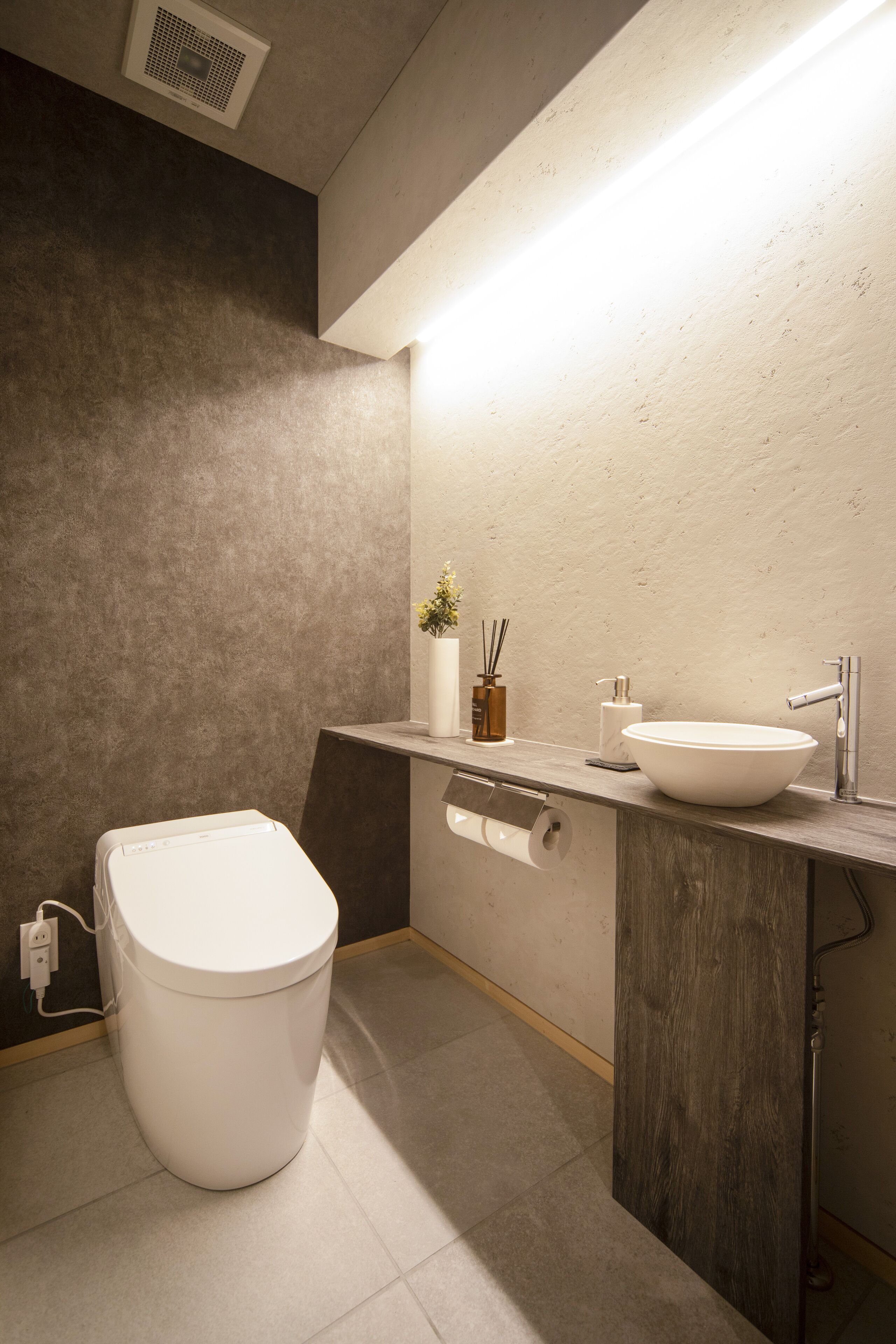 A modern bathroom with a toilet, sink, and shower.