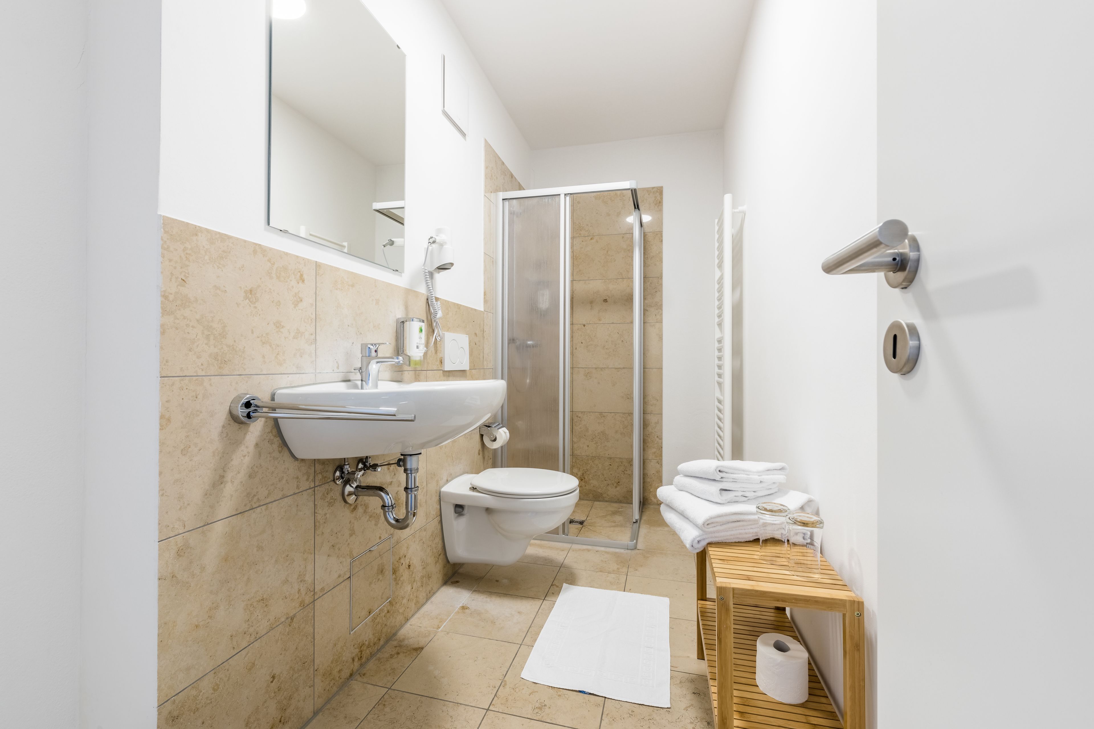 junior suite | bathroom | shower, hair dryer, towels, soap