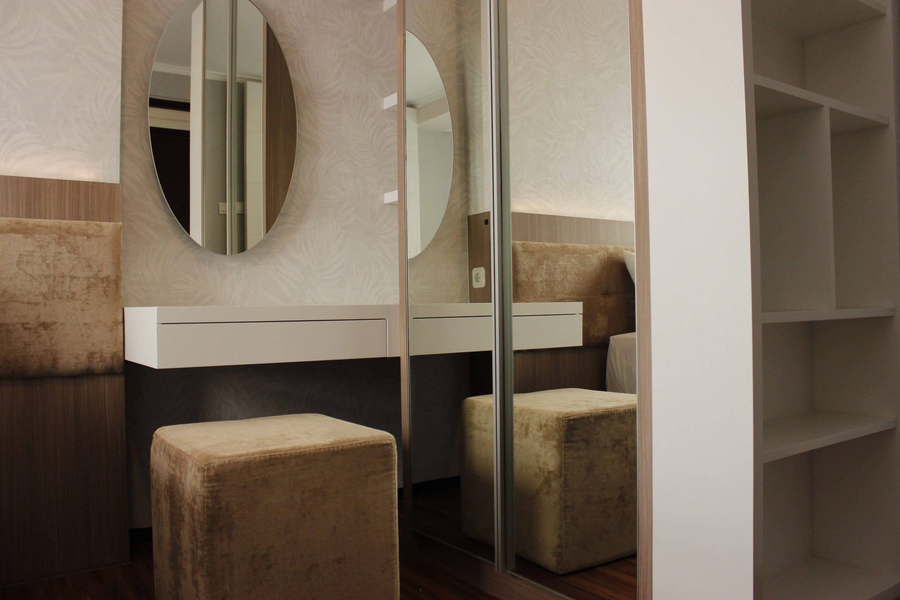 A modern bathroom with a vanity, two stools, and a mirror.