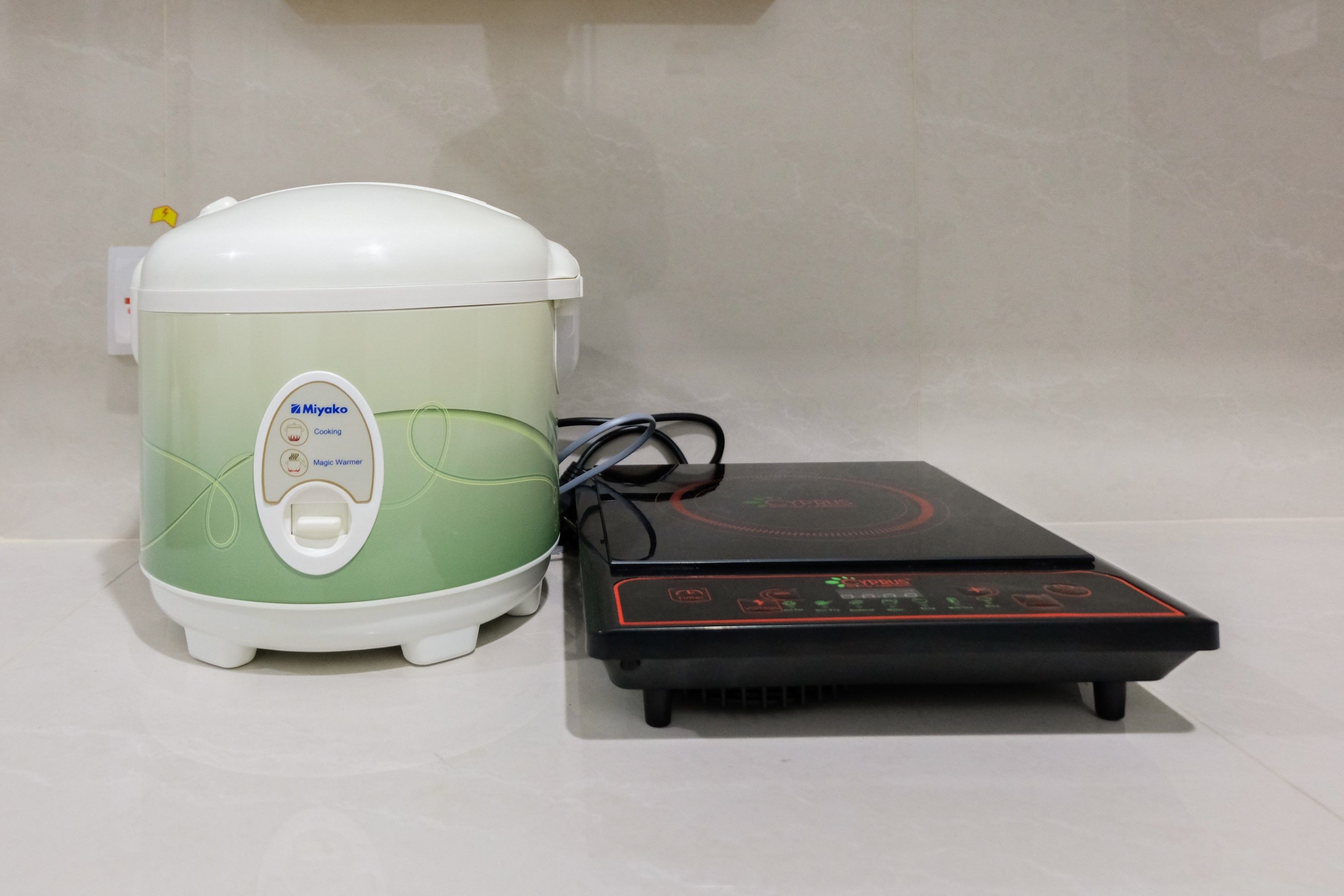 A rice cooker and a digital weighing scale.