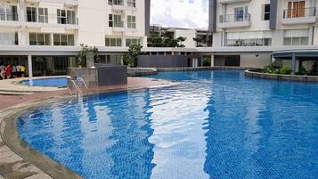 A modern residential building with a swimming pool.