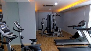 A gym with treadmills, elliptical machines, and weight equipment. - Elegant Studio Bassura Apartment (Jakarta)
