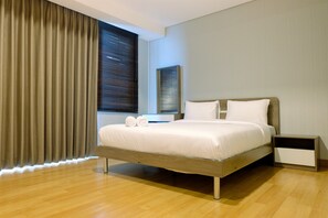 A modern bedroom with a wooden bed, a nightstand, and a window with blinds.