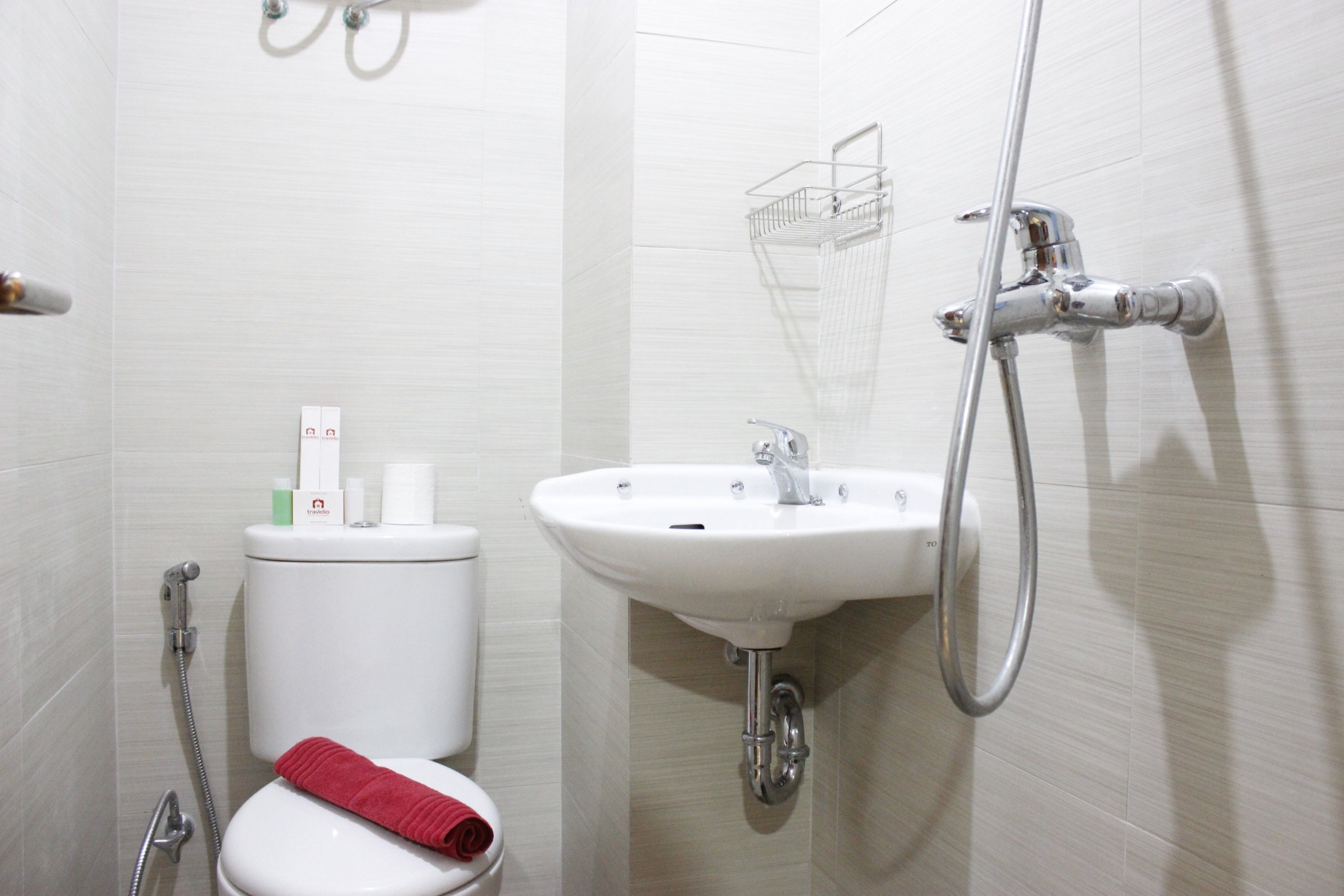 A bathroom with a toilet, sink, and shower.
