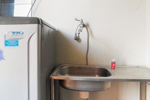 Room | Private kitchen | Fridge, stovetop, cookware/dishes/utensils - Pool View 2BR at Dian Regency Apartment (Surabaya)