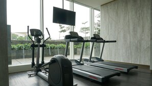 A gym with treadmills, an elliptical, and a stationary bike. - Strategic 1BR Apartment at Ciputra International (Jakarta)