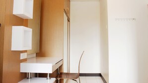 A modern bathroom with a wooden vanity, a white sink, and a mirror. - Strategic 1BR Apartment with Sofa Bed at The Jarrdin Cihampelas (Bandung)