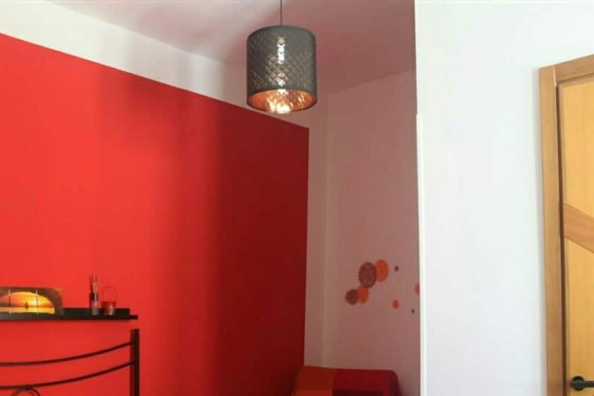 A room with a bed, a desk, and a chair.