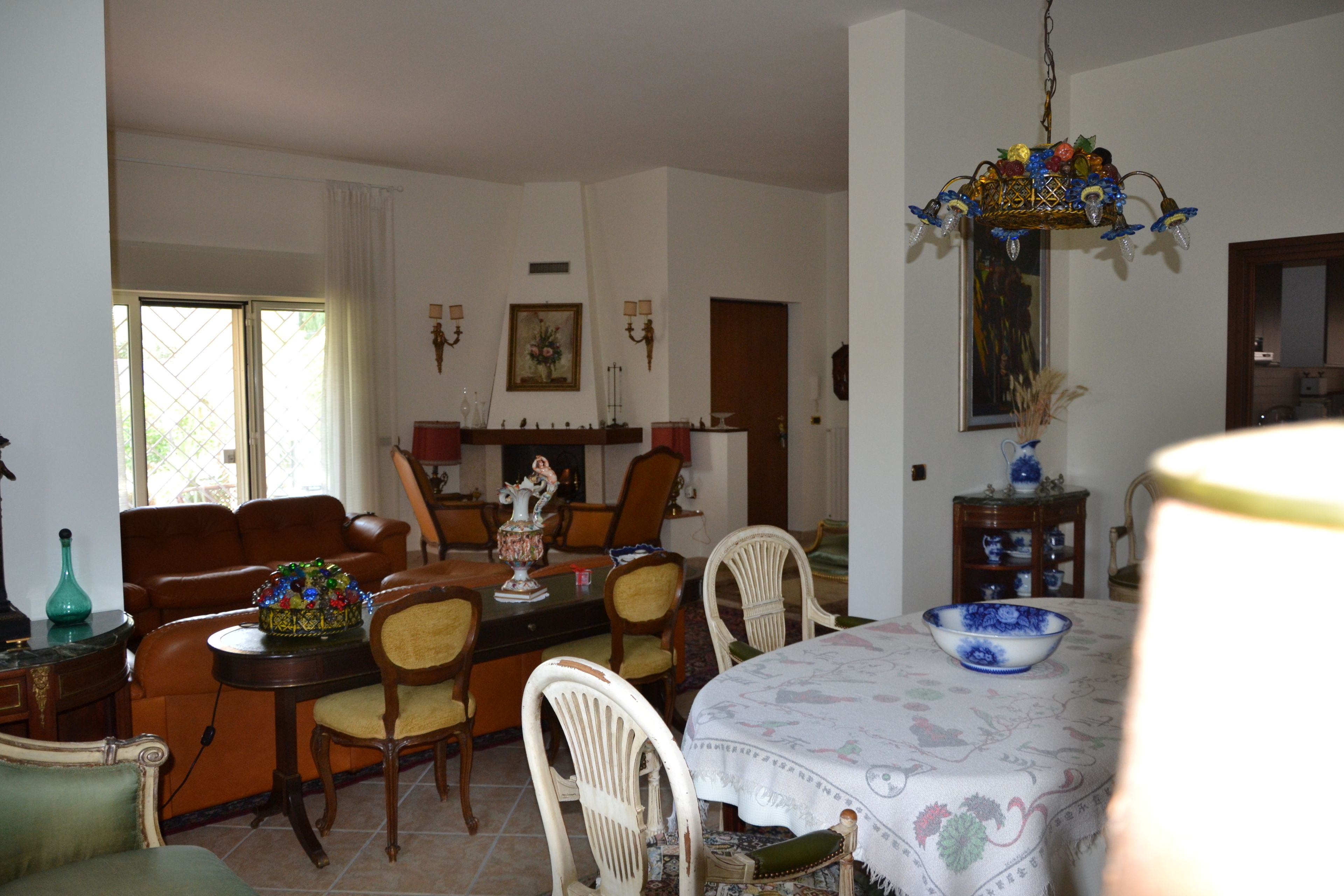 A dining area with a table set for four, surrounded by chairs.