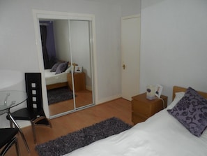 Premium bedding, memory-foam beds, laptop workspace, blackout curtains