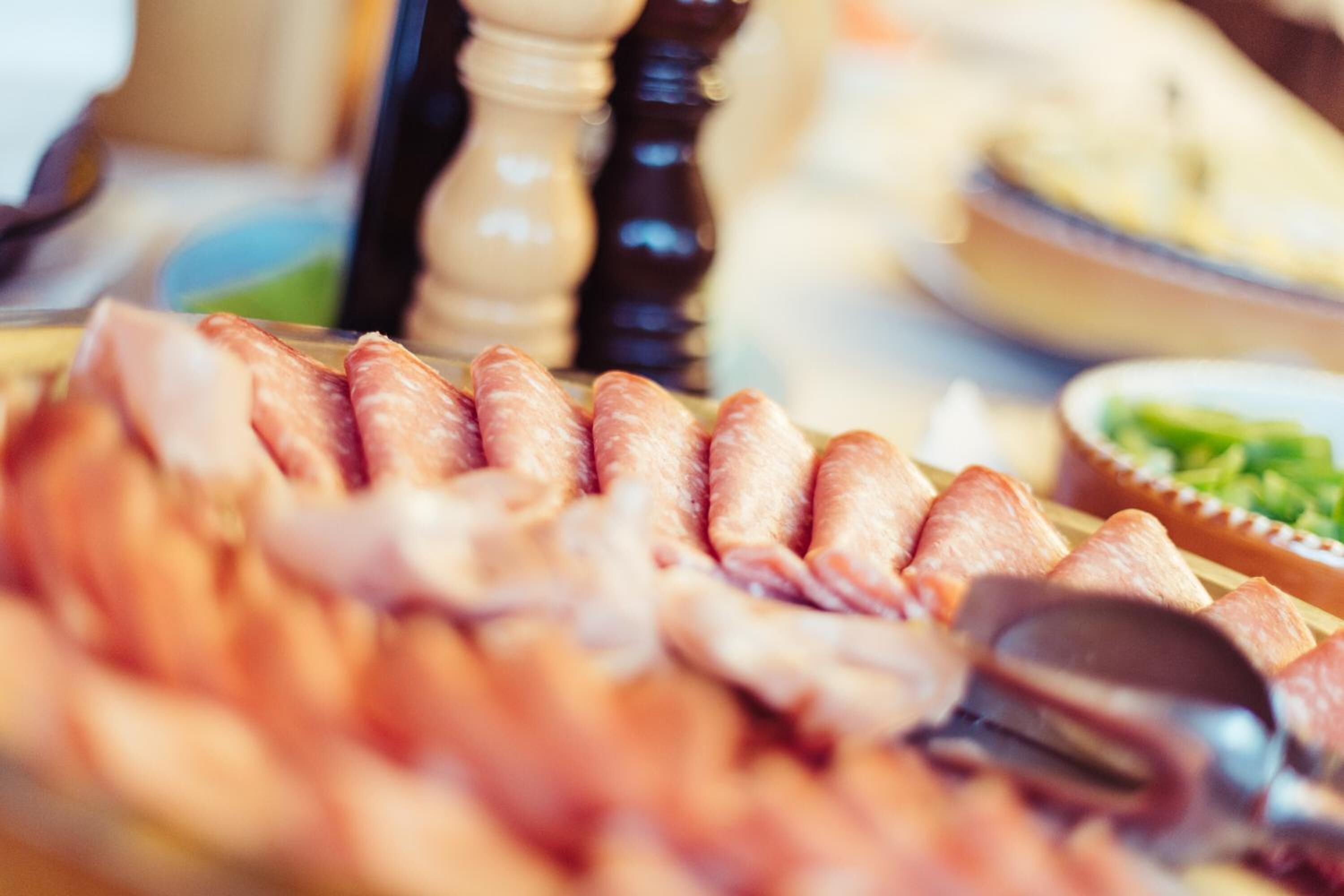 A platter of sliced meats, likely for a buffet.