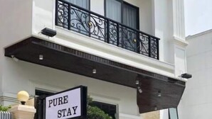 A hotel entrance with a sign reading "PURE STAY". - Pure Stay (Hai Phong)