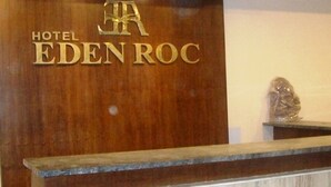 A wooden reception desk with the sign "HOTEL EDEN ROC". - Hotel Eden Roc (Bhubaneshwar)