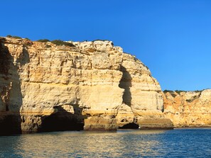 A coastal cliff with a natural cave entrance.