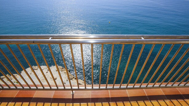 A balcony with a metal railing overlooking a body of water. - SOBREMAR Apartment - STUNNING Views (Salou)