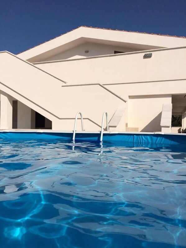 Seasonal outdoor pool, pool umbrellas, pool loungers