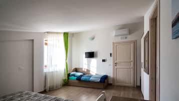 Triple Room | 1 bedroom, minibar, in-room safe, individually decorated