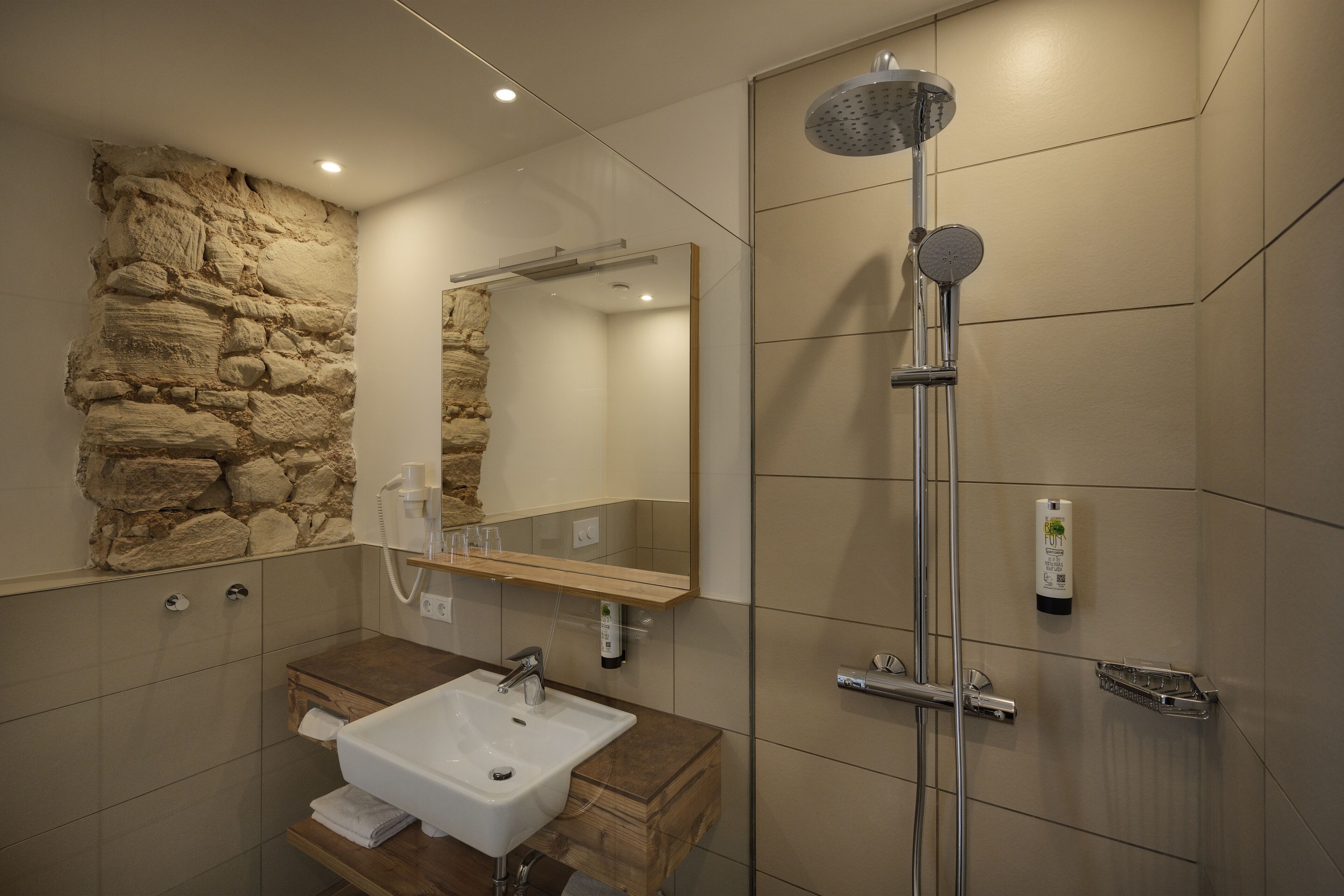 comfort apartment, 1 king bed | bathroom | rainfall showerhead, hair dryer, towels, soap