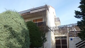 A building with a stone pathway leading to a gated entrance. - Barac Apartments (Novi Vinodolski)