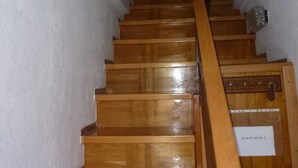 A wooden staircase with a sign reading "APARTMAN 2" leading to a room. - Barac Apartments (Novi Vinodolski)
