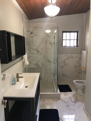 Comfort Apartment | Bathroom | Shower, slippers, towels - Beach Hideaway (Nassau)