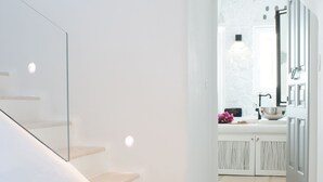 A modern staircase with a glass railing leading to a white interior space. - Euphoria Downtown (Naxos)