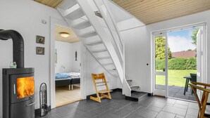 A modern interior with a fireplace, a staircase, and a view of the outdoors. - Pet friendly home in Børkop with WiFi (Børkop)