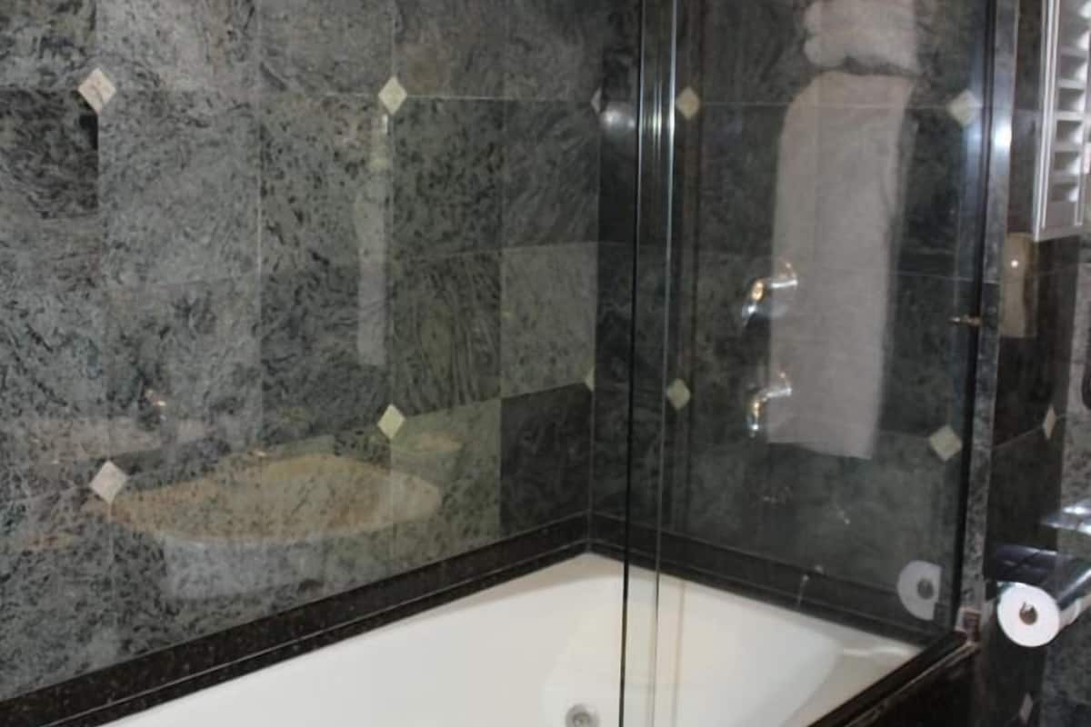 deluxe suite, jetted tub (master) | bathroom | hair dryer, bathrobes, slippers, bidet