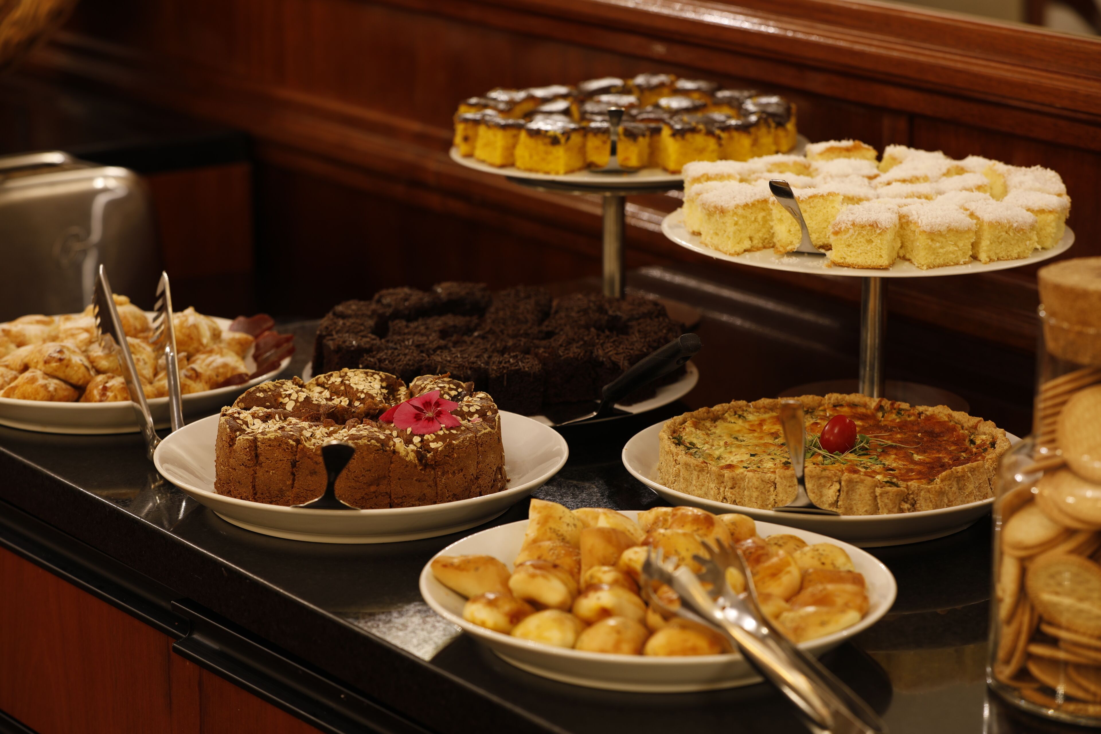 A buffet with various desserts and pastries.