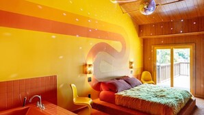 A modern bedroom with a large bed, a wooden ceiling, and a view of the outdoors. - The Dive Motel & Swim Club (Nashville)