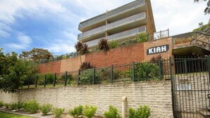 A multi-story building with a brick facade and a sign that reads "KIAH". - Kiah 8, 53 Victoria Parade - Stunning water views, Wifi & Air Con (Nelson Bay)