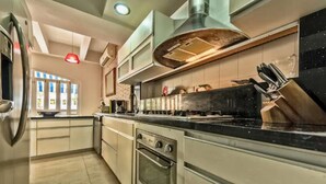 A modern kitchen with a central island, built-in oven, and stainless steel appliances. - Santo Domingo Condos by Velvet Luxury (Cartagena)